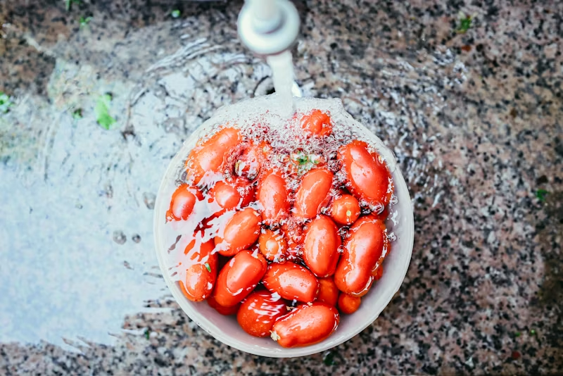 Washing a bowl of tomatoes