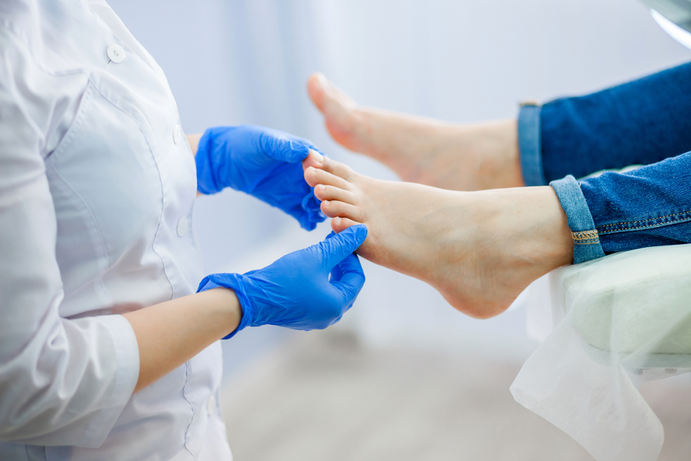 Podiatry doctor examines the foot