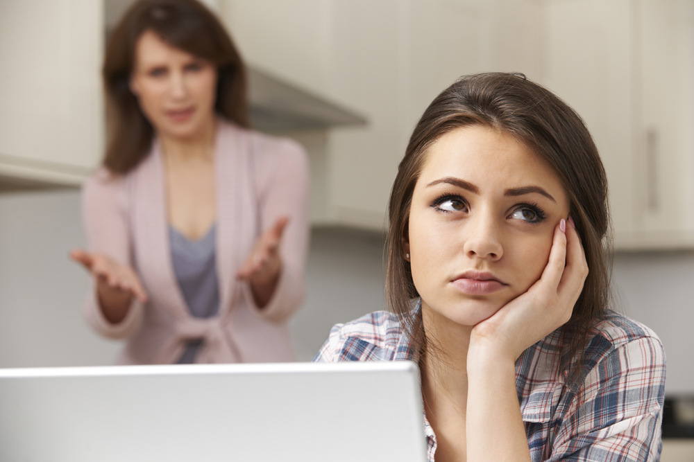 Mother Arguing With Teenage Daughter Over Online Activity